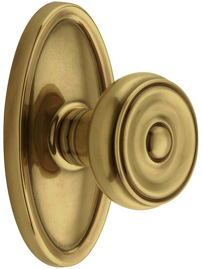 Oval Rosette Set With Waverly Knobs in Antique Brass.